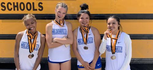 ARE THE HOLDENVILLE HIGH SCHOOL 4X400 RELAY TEAM MEMBERS HINTING THAT IT’S TIME TO EAT? The girls are trying to munch on their hard earned medals and they did accumulate several! The relay team members are Destiny Jennings, Dixie Gamble, Ryleigh Tiger and Chloe Tiger!